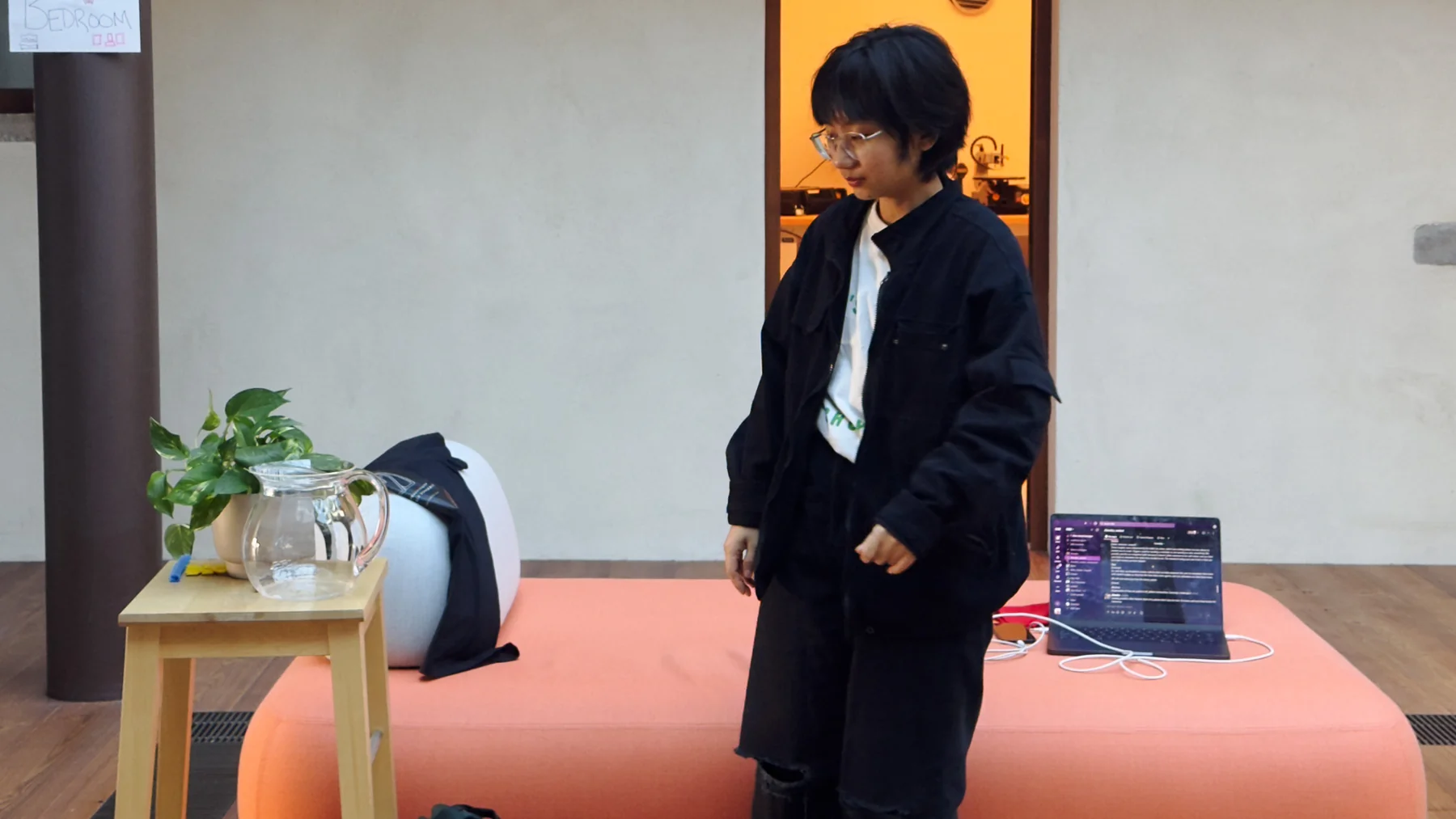 Testing the device near a plant and a water jug, in a mocked-up bedroom