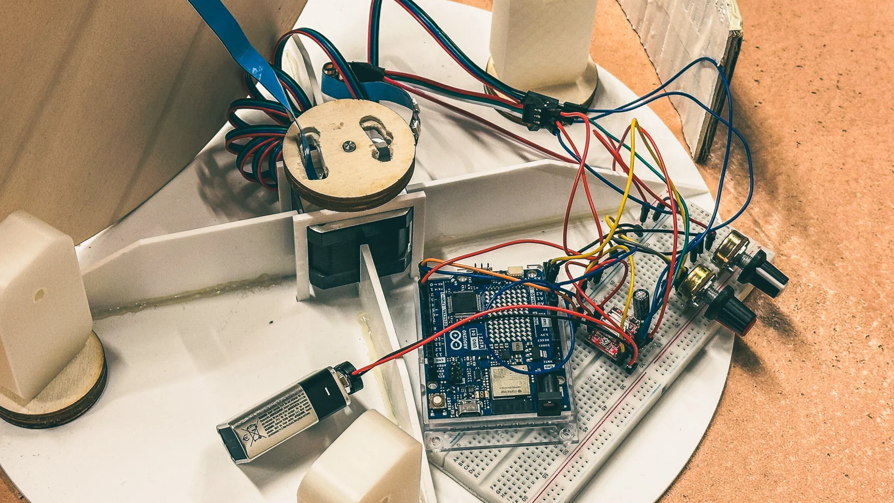 The electronics in the base: an Arduino, breadboard, motor and wiring
