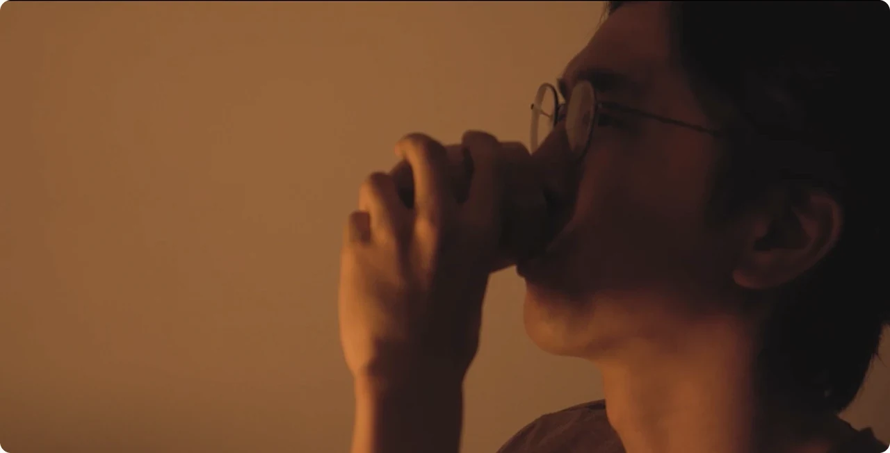 A participant drinking from the vessel